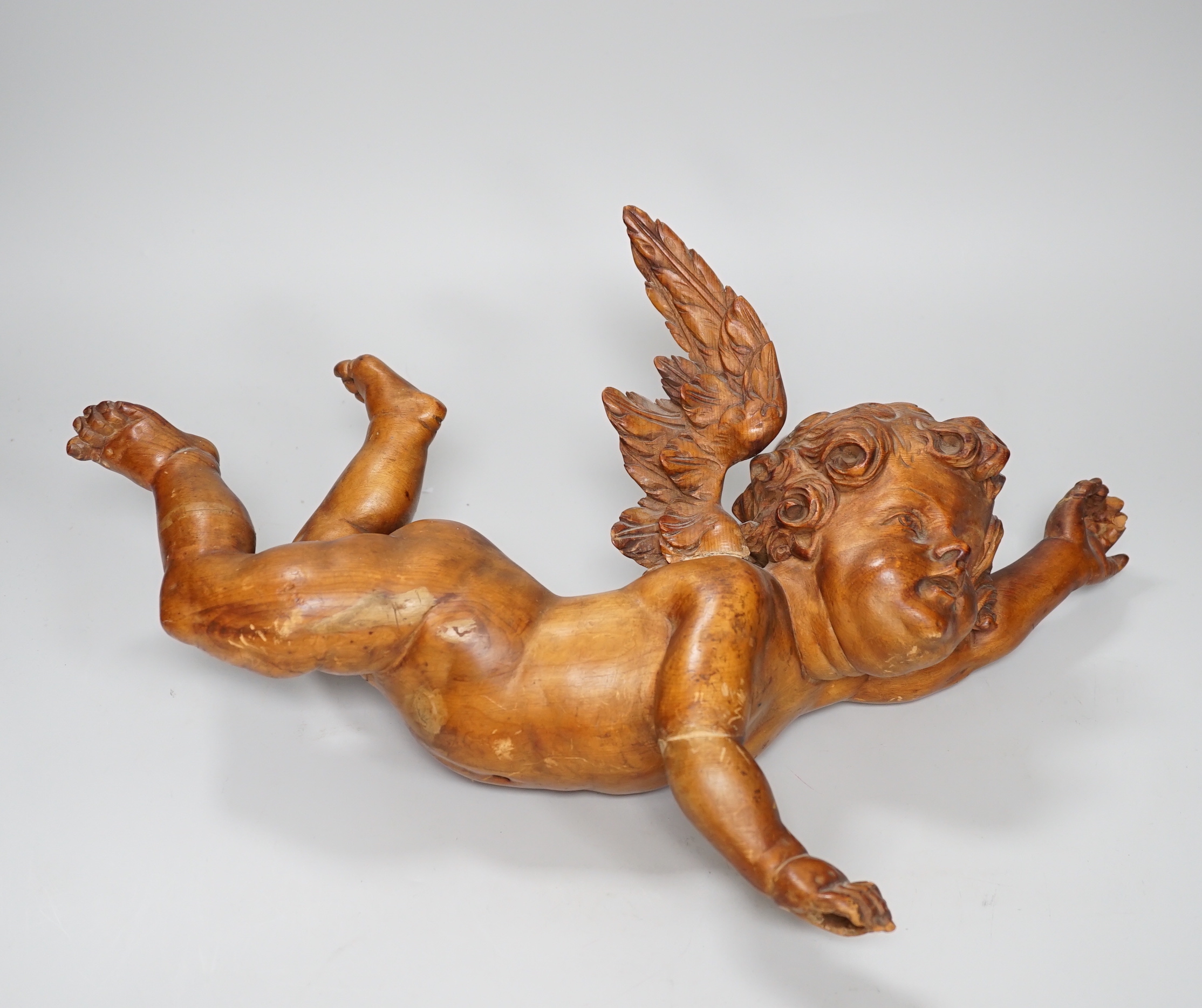 A carved pine cherub, 40cm (a.f.)